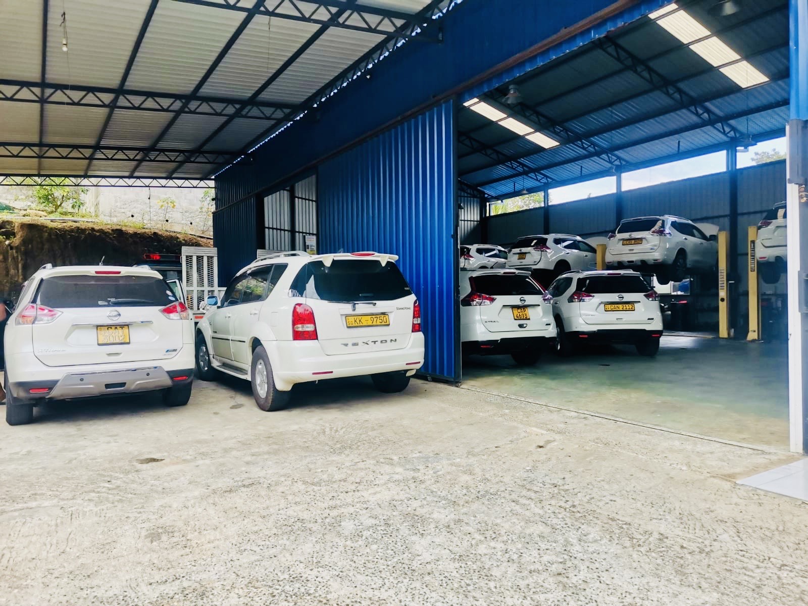 Technician comparing automatic and CVT transmission components at Dayara Auto Engineers, Balangoda